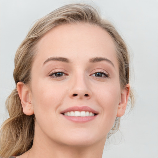 Joyful white young-adult female with long  brown hair and blue eyes