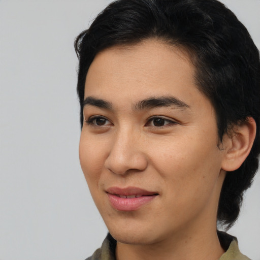 Joyful latino young-adult male with medium  brown hair and brown eyes