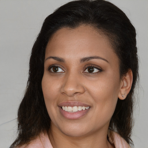 Joyful latino young-adult female with medium  brown hair and brown eyes