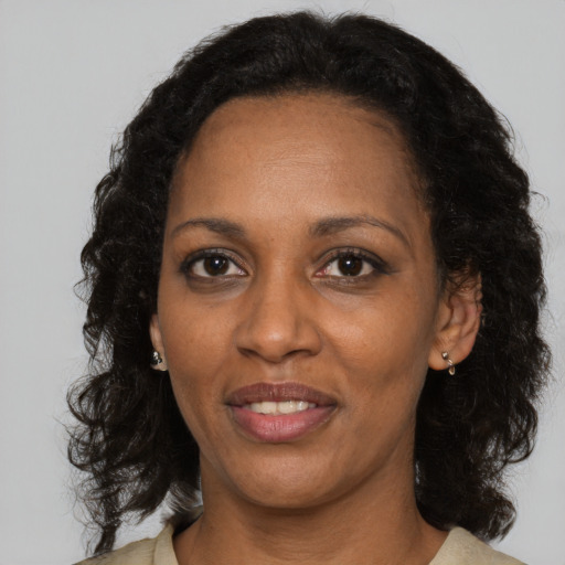Joyful black adult female with medium  black hair and brown eyes
