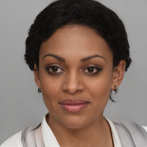 Joyful black young-adult female with short  brown hair and brown eyes