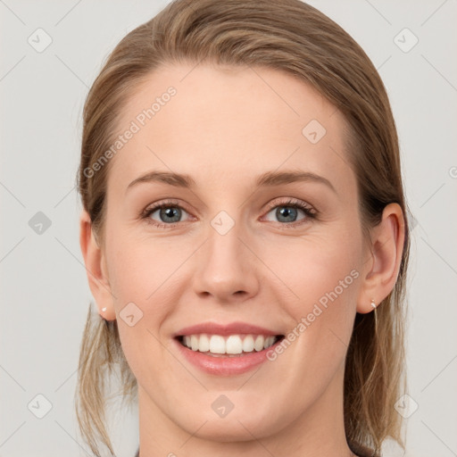 Joyful white young-adult female with medium  brown hair and blue eyes