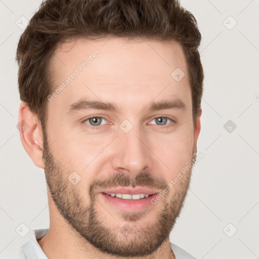 Joyful white young-adult male with short  brown hair and grey eyes