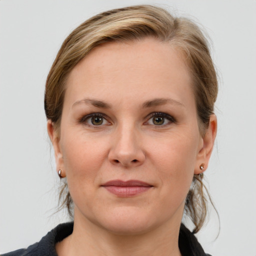 Joyful white adult female with medium  brown hair and grey eyes