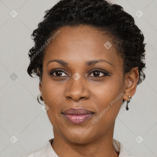 Joyful black adult female with short  black hair and brown eyes