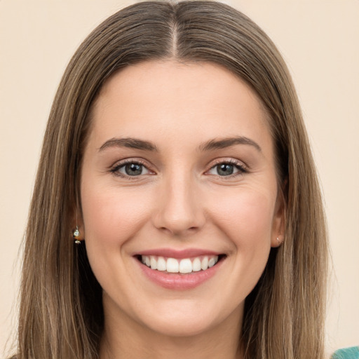 Joyful white young-adult female with long  brown hair and green eyes