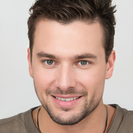 Joyful white young-adult male with short  brown hair and brown eyes