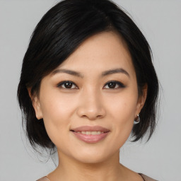 Joyful asian young-adult female with medium  black hair and brown eyes