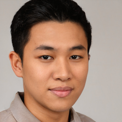 Joyful latino young-adult male with short  brown hair and brown eyes