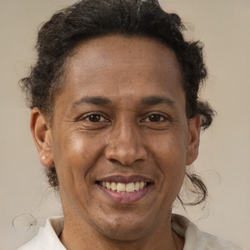 Joyful black adult male with short  brown hair and brown eyes