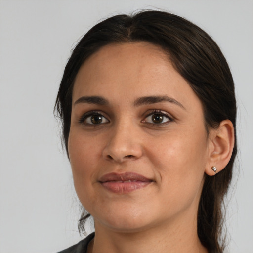 Joyful latino young-adult female with medium  brown hair and brown eyes