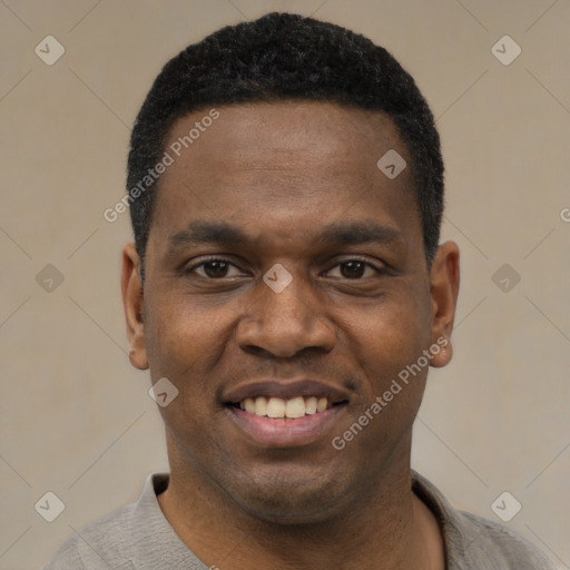 Joyful black young-adult male with short  black hair and brown eyes