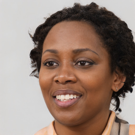 Joyful black young-adult female with medium  brown hair and brown eyes