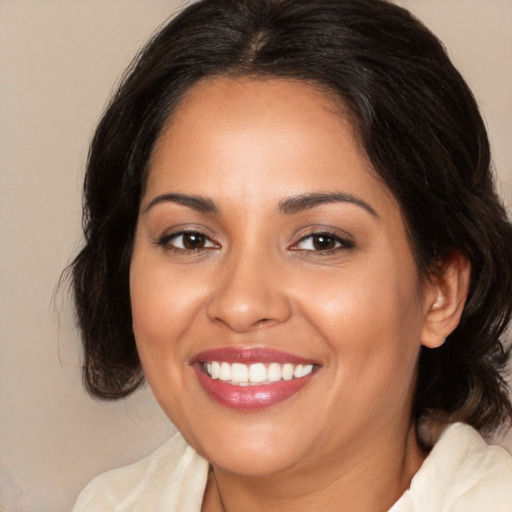 Joyful latino young-adult female with medium  brown hair and brown eyes