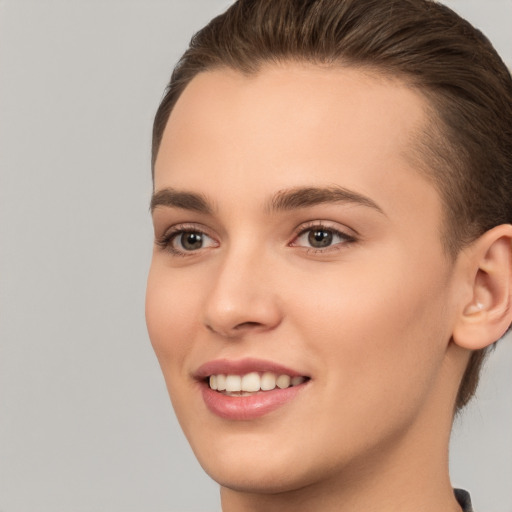 Joyful white young-adult female with short  brown hair and brown eyes