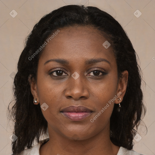 Joyful black young-adult female with long  brown hair and brown eyes