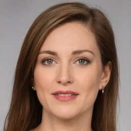 Joyful white young-adult female with long  brown hair and green eyes