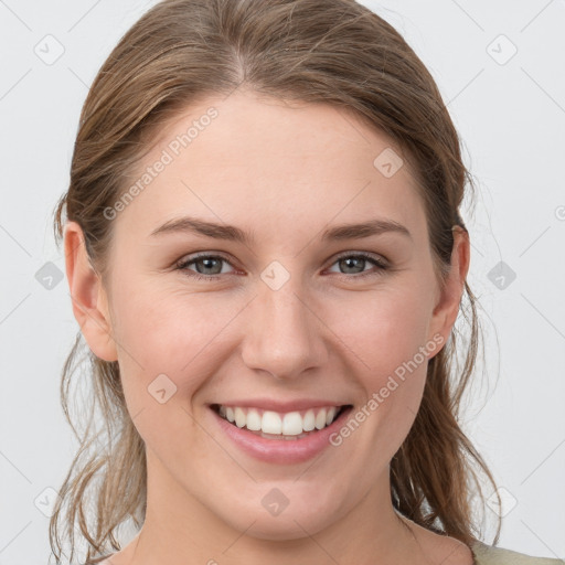 Joyful white young-adult female with medium  brown hair and grey eyes