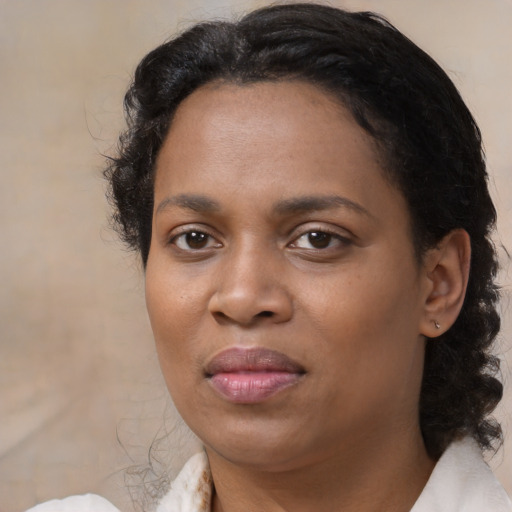 Joyful black adult female with medium  black hair and brown eyes
