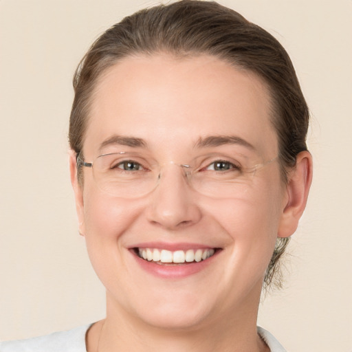 Joyful white adult female with medium  brown hair and grey eyes