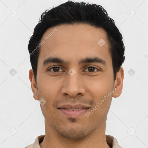 Joyful latino young-adult male with short  black hair and brown eyes