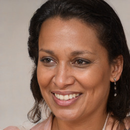 Joyful black adult female with medium  brown hair and brown eyes