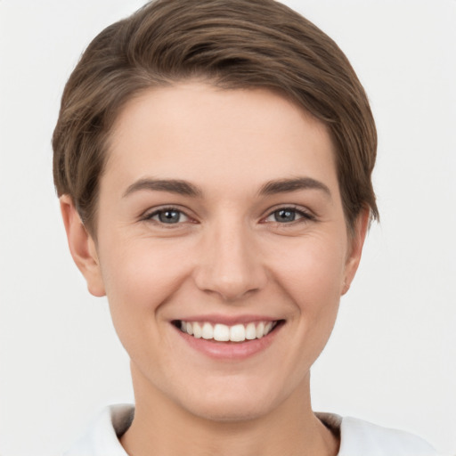 Joyful white young-adult female with short  brown hair and brown eyes