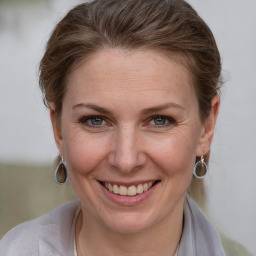 Joyful white young-adult female with short  brown hair and grey eyes