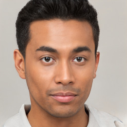 Joyful latino young-adult male with short  brown hair and brown eyes