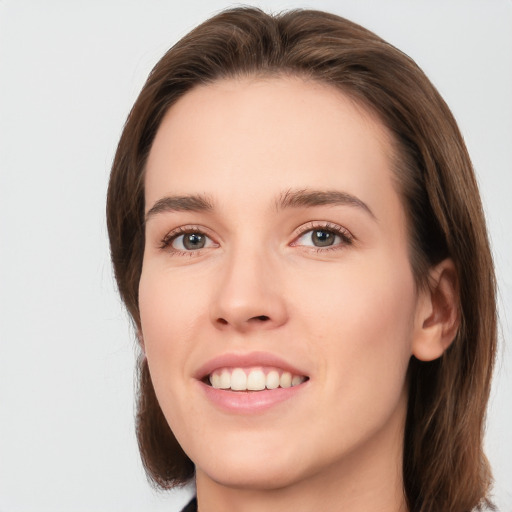 Joyful white young-adult female with medium  brown hair and green eyes