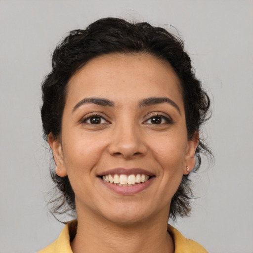 Joyful latino young-adult female with medium  brown hair and brown eyes