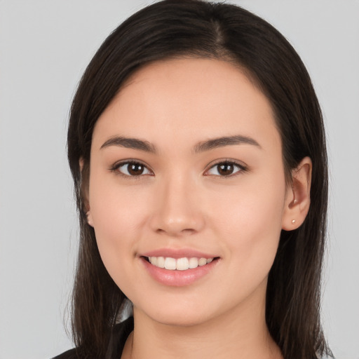 Joyful white young-adult female with long  brown hair and brown eyes