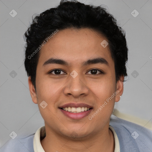 Joyful latino young-adult male with short  brown hair and brown eyes