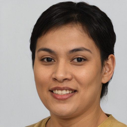 Joyful asian young-adult female with short  brown hair and brown eyes
