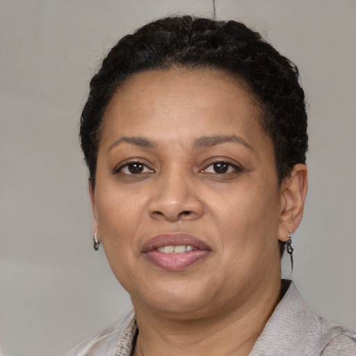 Joyful black adult female with short  brown hair and brown eyes
