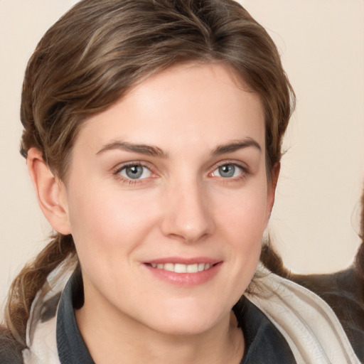 Joyful white young-adult female with medium  brown hair and grey eyes