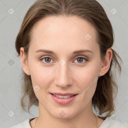 Joyful white young-adult female with medium  brown hair and grey eyes