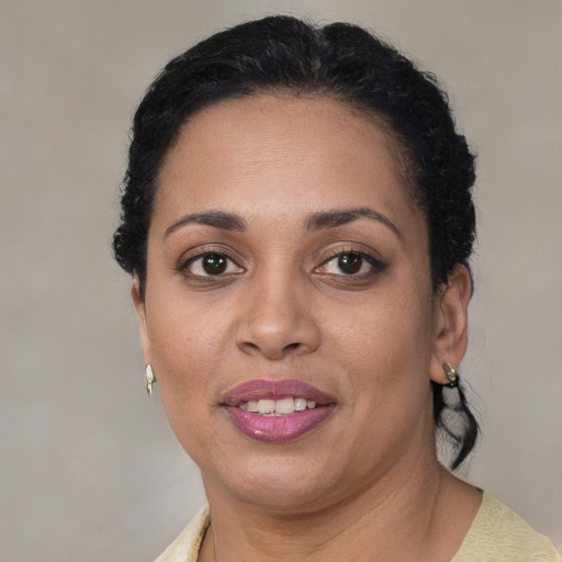 Joyful latino adult female with short  brown hair and brown eyes