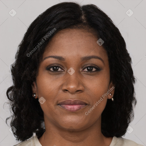 Joyful black adult female with long  brown hair and brown eyes