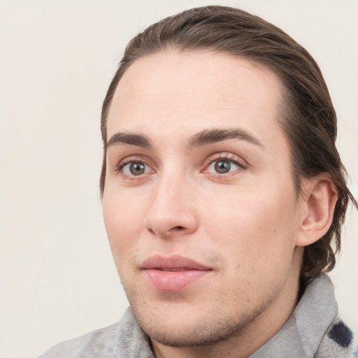 Joyful white young-adult male with medium  brown hair and grey eyes