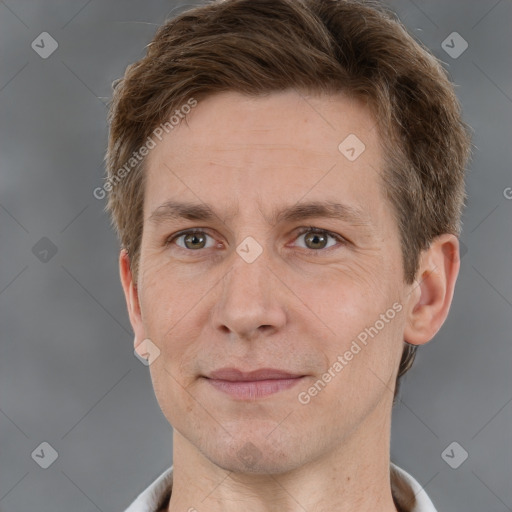 Joyful white adult male with short  brown hair and grey eyes