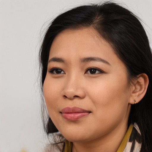 Joyful asian young-adult female with long  black hair and brown eyes