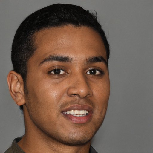 Joyful black young-adult male with short  brown hair and brown eyes