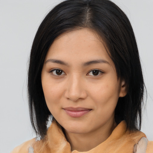 Joyful asian young-adult female with medium  brown hair and brown eyes