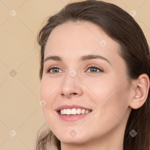 Joyful white young-adult female with long  brown hair and brown eyes