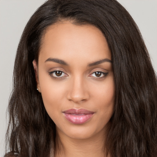 Joyful latino young-adult female with long  brown hair and brown eyes