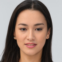 Joyful asian young-adult female with long  brown hair and brown eyes