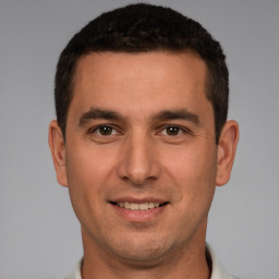 Joyful white young-adult male with short  brown hair and brown eyes