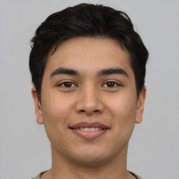 Joyful asian young-adult male with short  brown hair and brown eyes