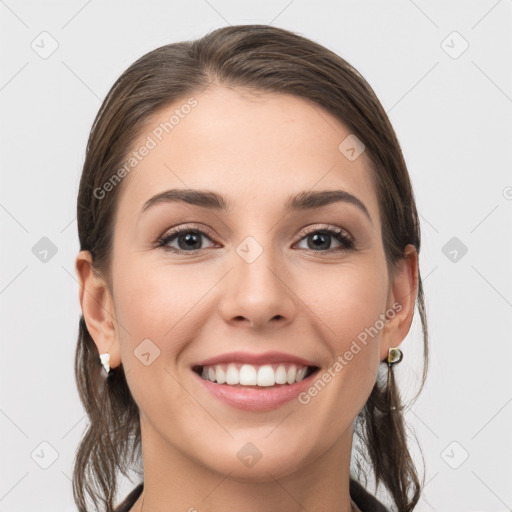 Joyful white young-adult female with long  brown hair and grey eyes